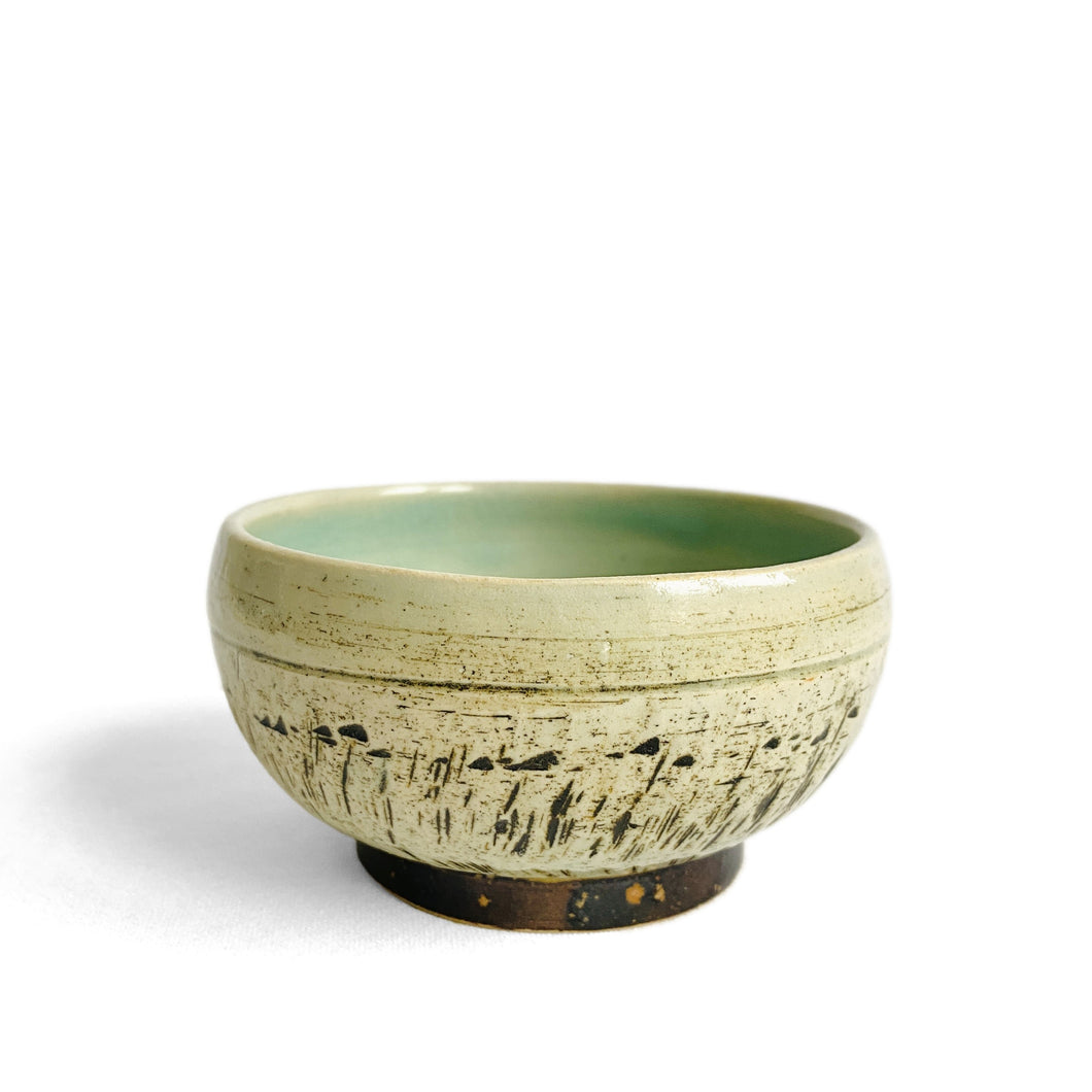 Pale green celadon glazed bowl with chattered pattern